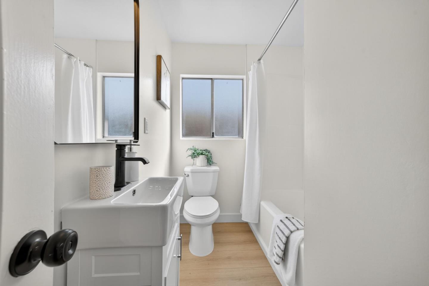 1236 Whitton Avenue San Jose, CA 95116 - Photo 15 of 30 a bathroom with a toilet sink and mirror