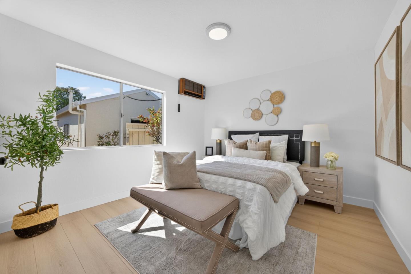 1236 Whitton Avenue San Jose, CA 95116 - Photo 17 of 30 a bedroom with a bed and a potted plant