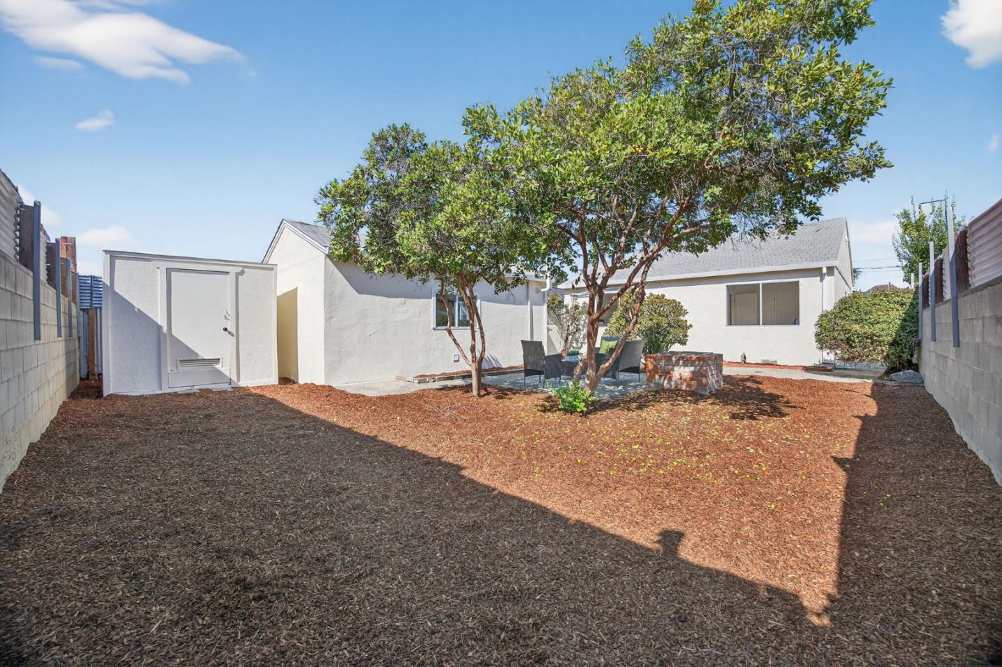 1236 Whitton Avenue San Jose, CA 95116 - Photo 21 of 30 a house with trees in front of it