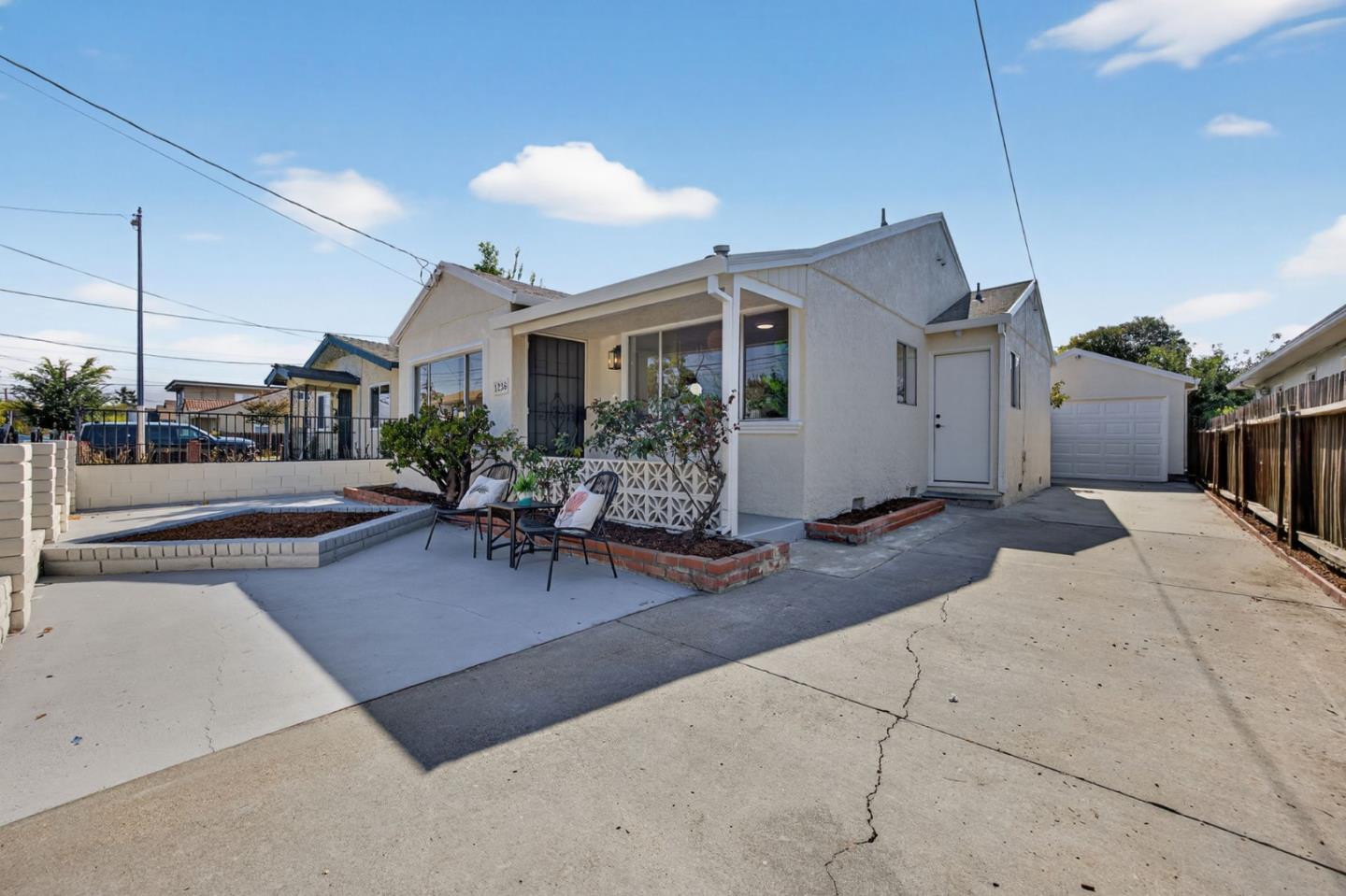 1236 Whitton Avenue San Jose, CA 95116 - Photo 4 of 30 a building outdoor space with patio furniture and potted plants