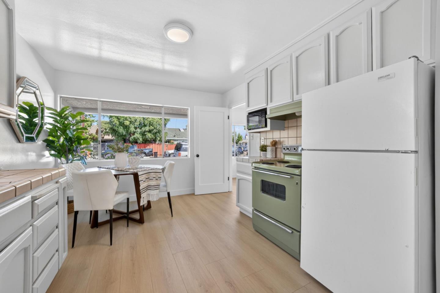 1236 Whitton Avenue San Jose, CA 95116 - Photo 6 of 30 a kitchen with stainless steel appliances a refrigerator a sink and a white cabinets