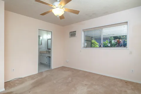 a view of room with window and a ceiling fan