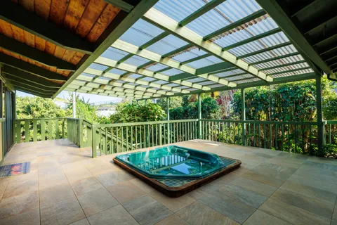 a view of a big room with wooden floor and windows