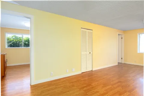 a room with wooden floors and cabinet