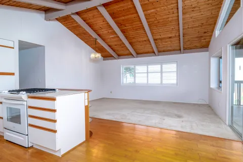 a kitchen with a refrigerator and window
