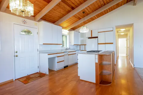 a kitchen with a stove a sink and a refrigerator