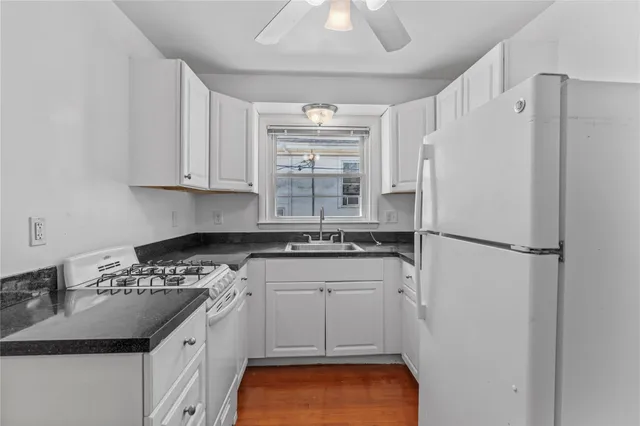 a kitchen with a white cabinets and white appliances