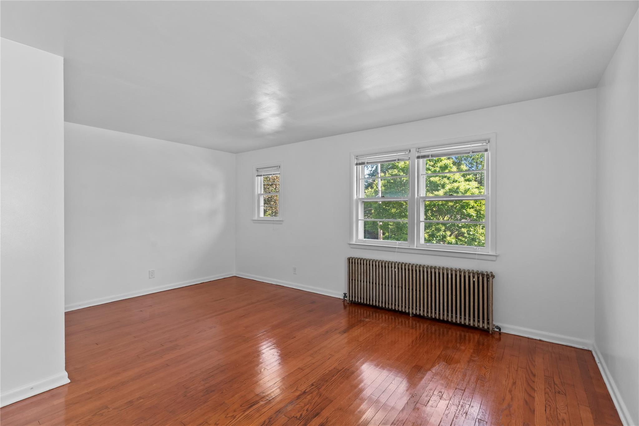 17 College Avenue, Unit 2 Poughkeepsie, NY 12603 - Photo 5 of 12 an empty room with wooden floor and windows
