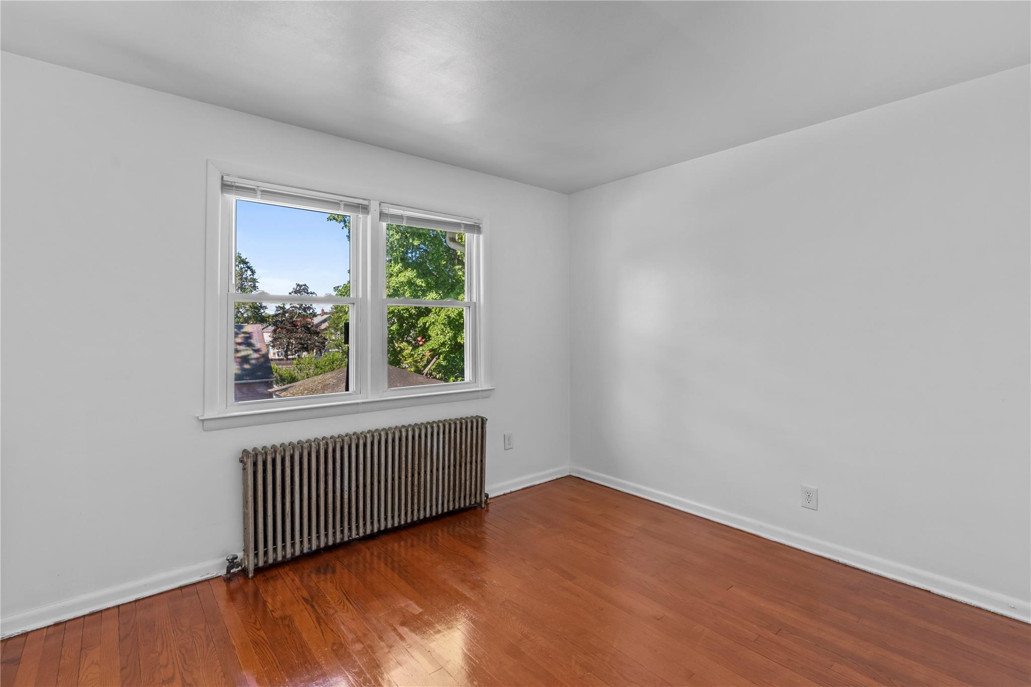 17 College Avenue, Unit 2 Poughkeepsie, NY 12603 - Photo 7 of 12 an empty room with wooden floor and windows