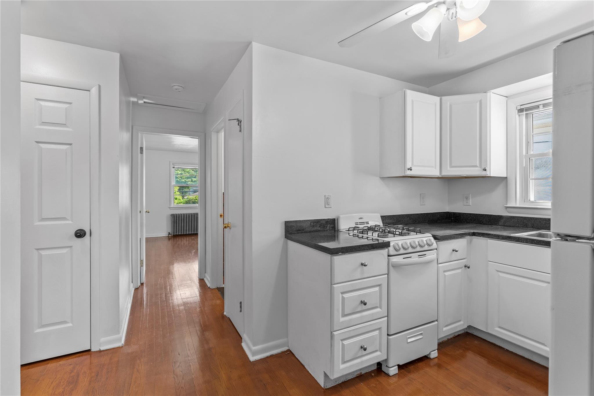 17 College Avenue, Unit 2 Poughkeepsie, NY 12603 - Photo 9 of 12 a kitchen with white cabinets and white appliances
