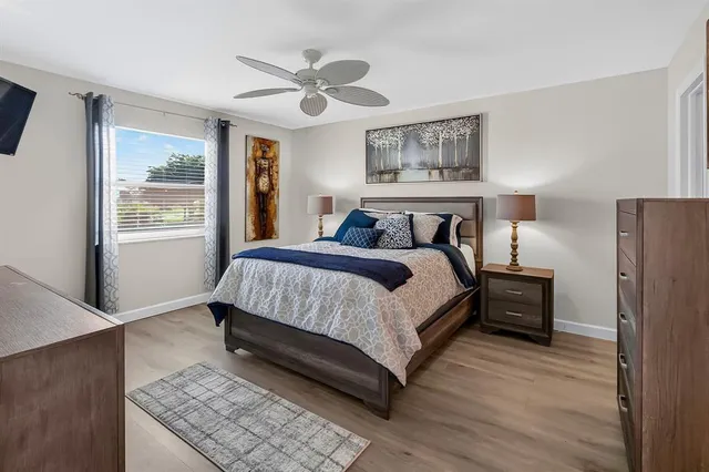 a bedroom with a bed lamp and a window