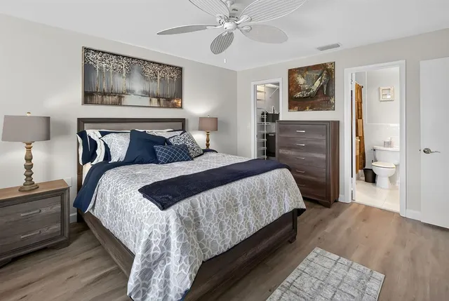 a bedroom with bed and painting on the wall