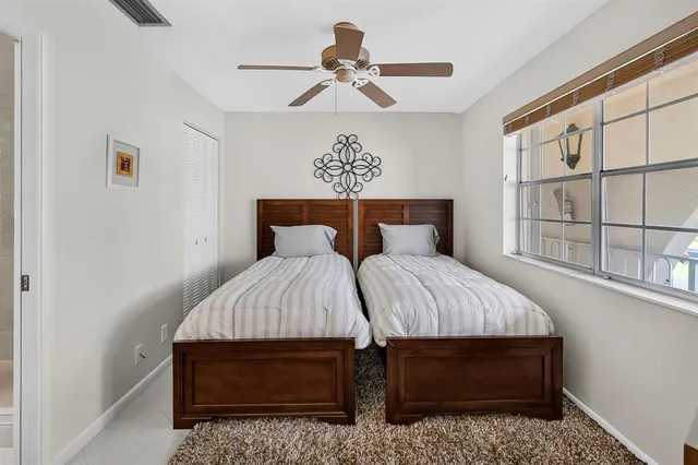 a bed sitting in a bedroom next to a window