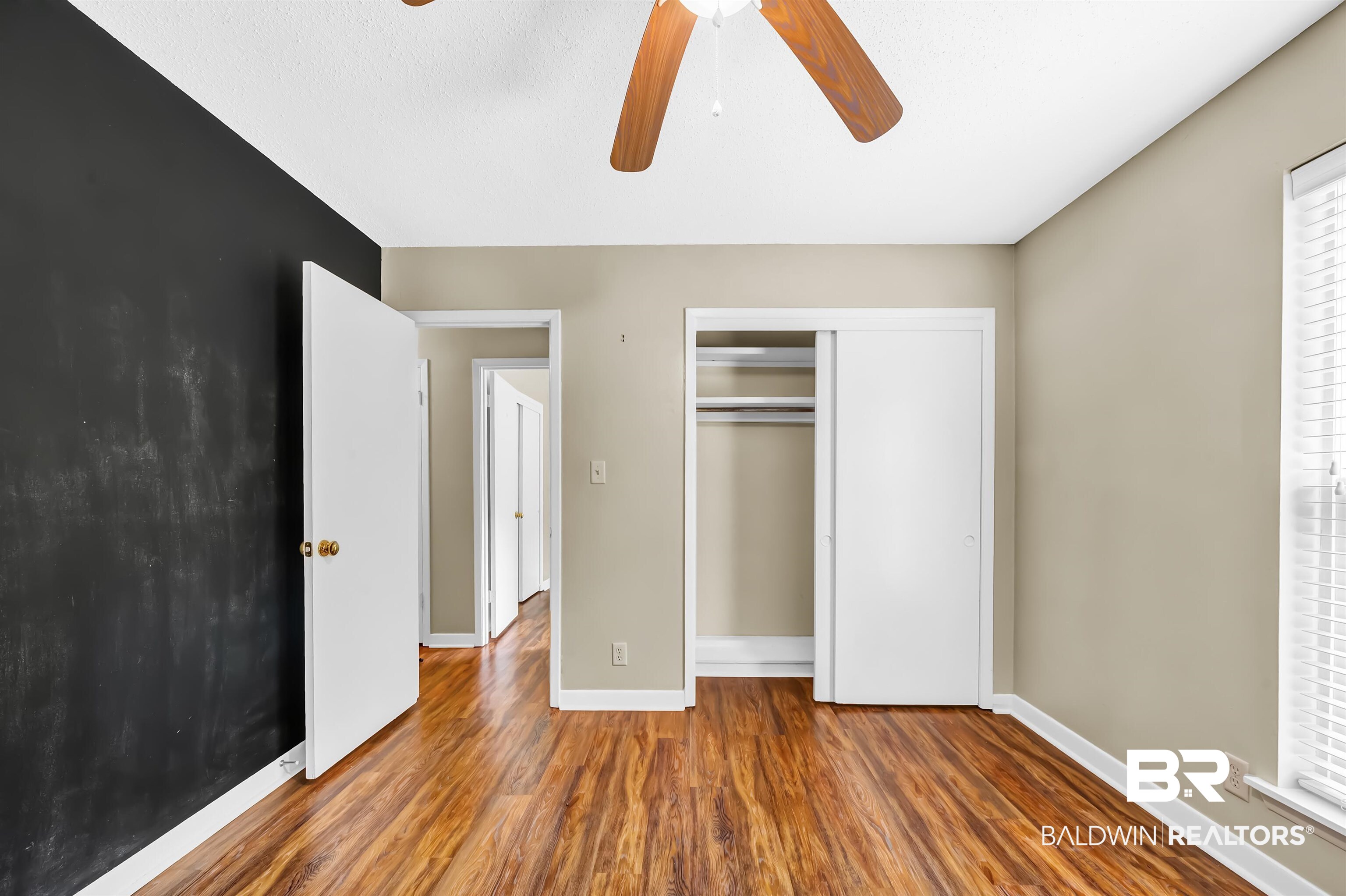 28 Caisson Trace Spanish Fort, AL 36527 - Photo 38 of 51 Unfurnished bedroom with baseboards, wood finished floors, ceiling fan, and a closet