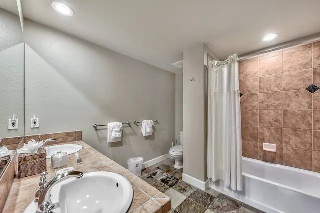 a en suite bathroom with toilet sink and shower