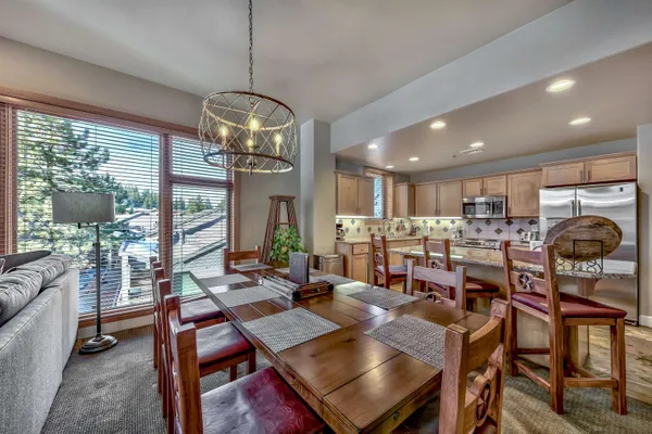 a view of a dining room with furniture wooden floor and chandelier