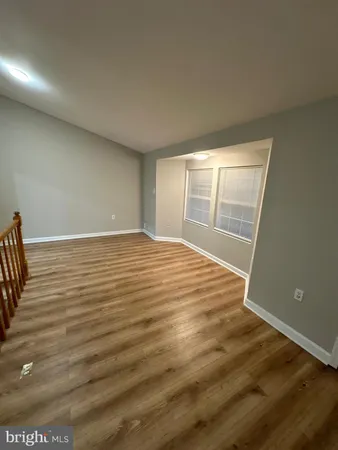 a view of a room with wooden floor and chair