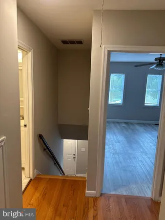 a view of room with window and hardwood floor