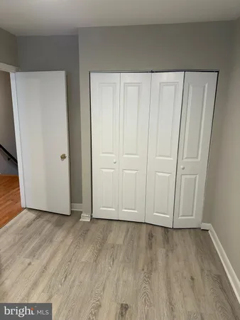 a view of a livingroom with a ceiling fan and hardwood floor