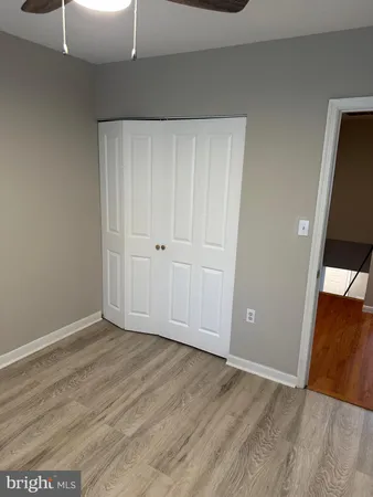 a view of a room with wooden floor and staircase