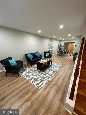 a view of a room with furniture and wooden floor