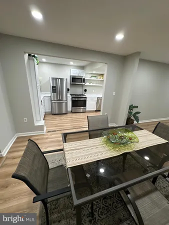 a kitchen with stainless steel appliances kitchen island granite countertop a sink refrigerator and cabinets