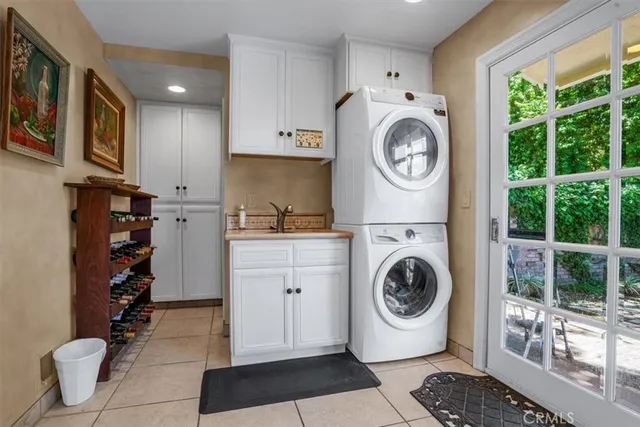 a kitchen with white cabinets and wooden floors