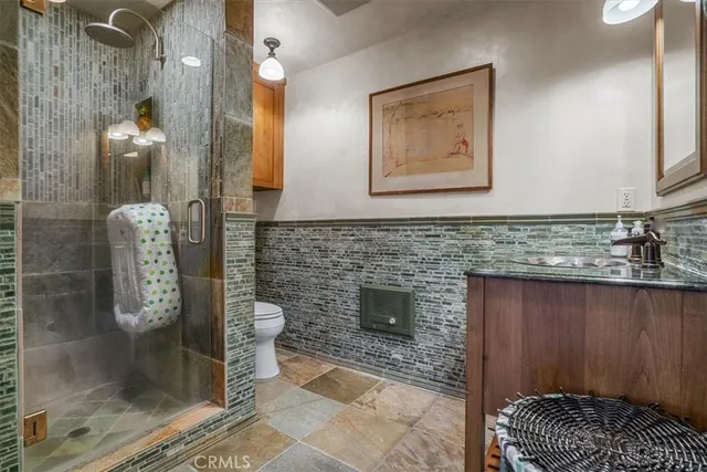 a bedroom with a bed and large windows