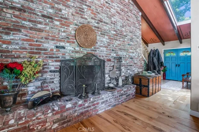 a view of a dining room with furniture a chandelier and wooden floor