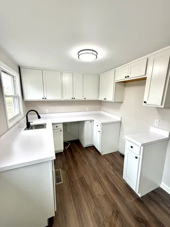 a kitchen with a sink appliances and cabinets
