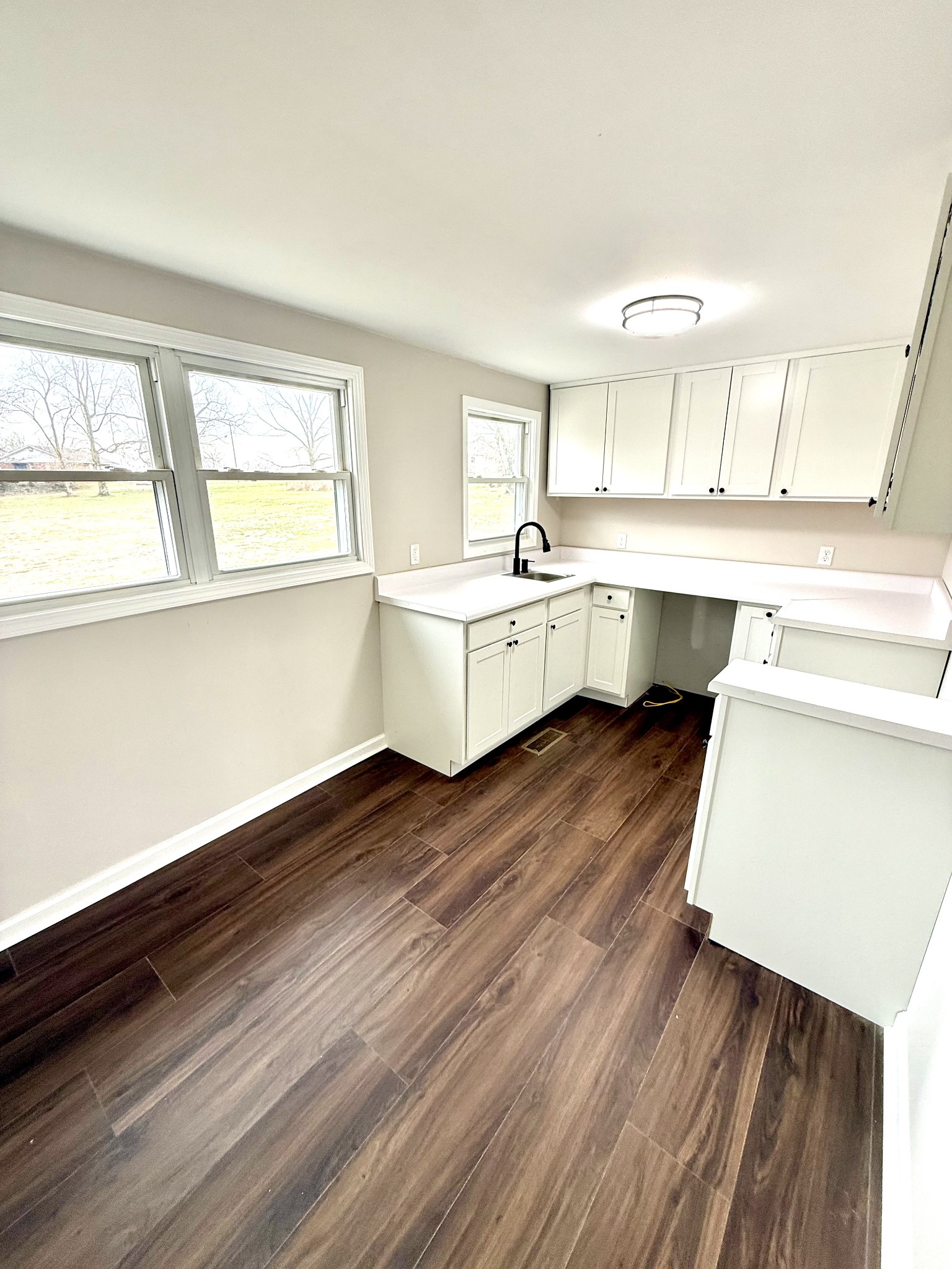 141 Main Street Gracey, KY 42232 - Photo 6 of 16 a kitchen with wooden floors and white appliances
