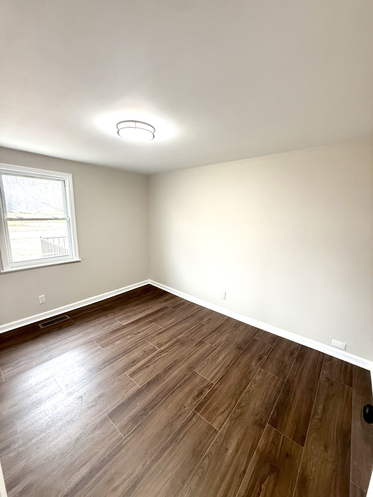 141 Main Street Gracey, KY 42232 - Photo 9 of 16 an empty room with wooden floor and windows
