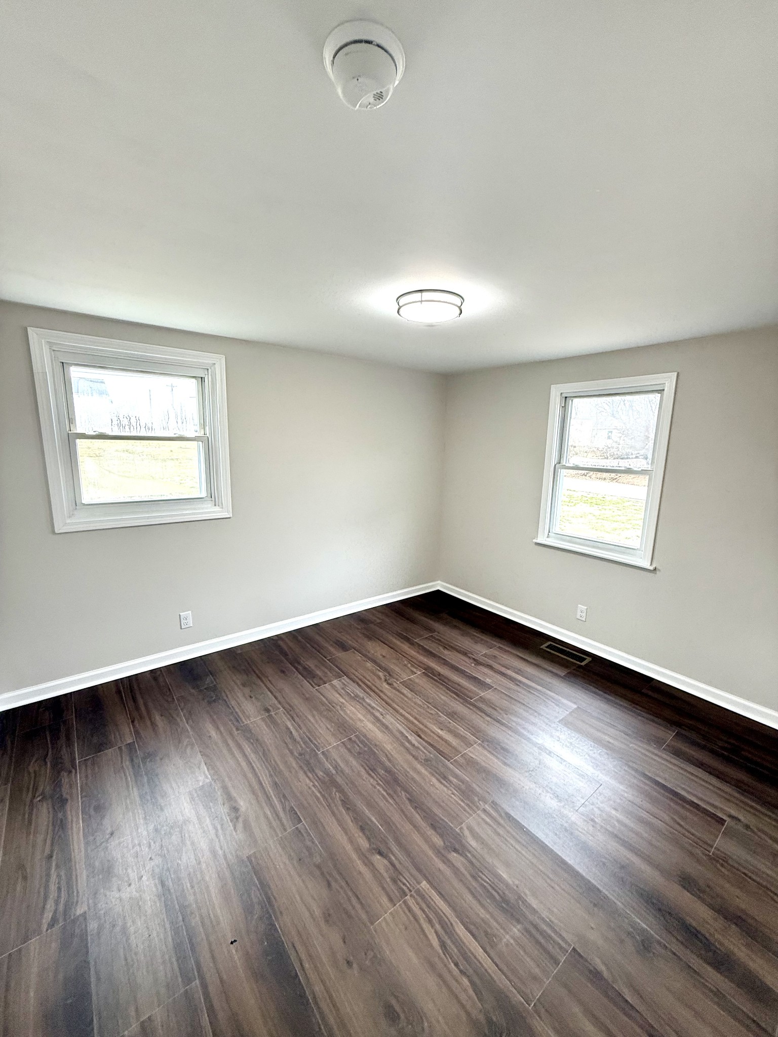 141 Main Street Gracey, KY 42232 - Photo 10 of 16 an empty room with wooden floor and windows