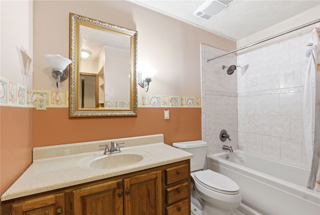 6711 Hamilton-Middletown Road Franklin, OH 45005 - Photo 20 of 49 This bathroom features a functional vanity and a tiled shower-tub combination for daily routines.