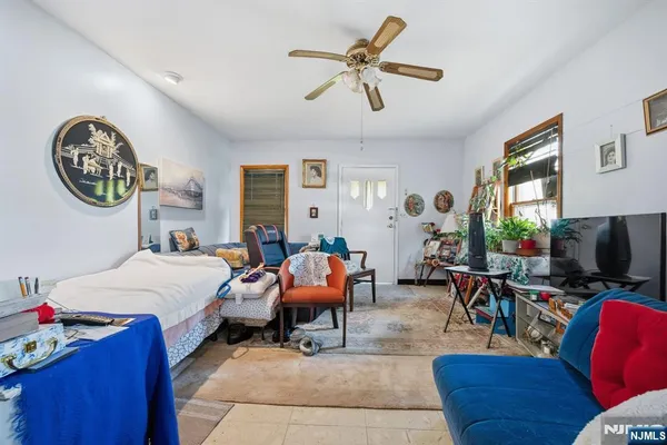 a living room with furniture a window and a flat screen tv