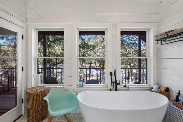 a bath tub sitting in front of a window