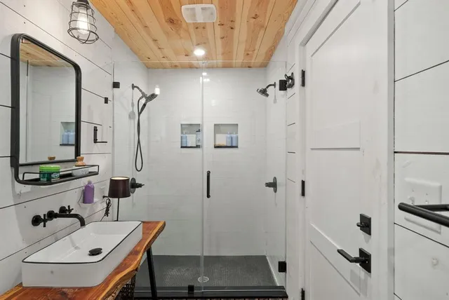 a bathroom with a sink a vanity and shower
