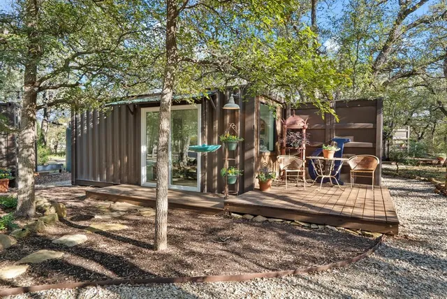 a view of a backyard with wooden fence