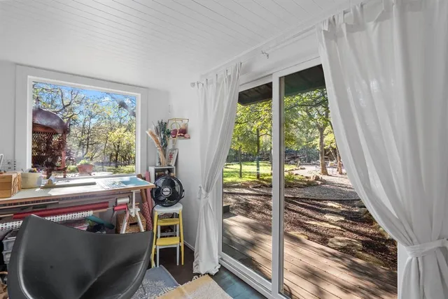 a view of a house with backyard and sitting area