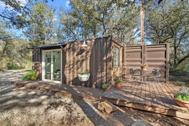 a bedroom with a bed and large windows