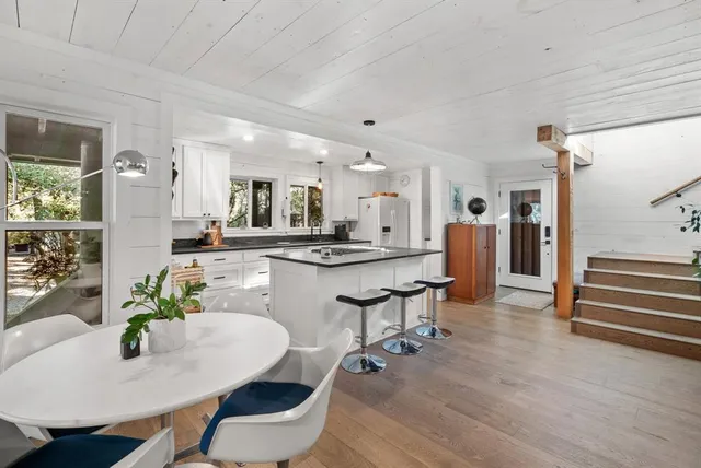 a living room with kitchen island furniture and a kitchen view