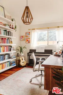 a bedroom with furniture and a window