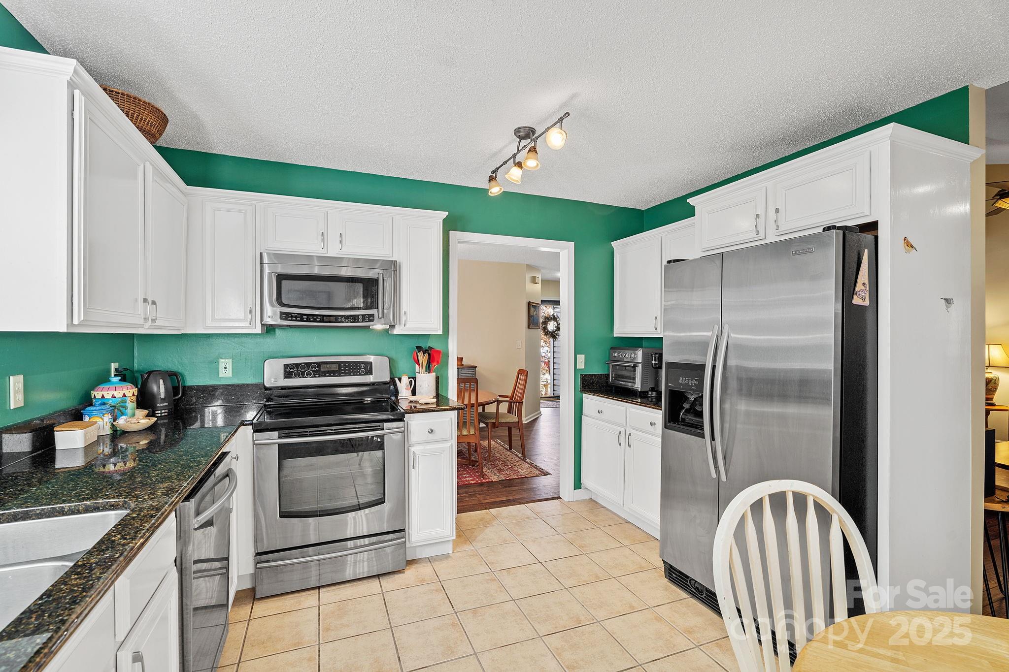 28 Sand Pebble Court Fletcher, NC 28732 - Photo 11 of 35 a kitchen with stainless steel appliances a refrigerator sink and microwave