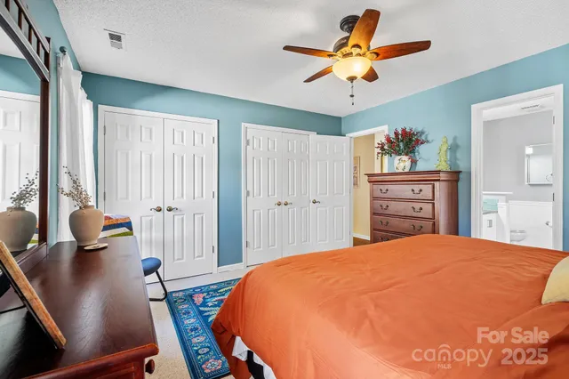a bathroom with a granite countertop sink a toilet and a mirror