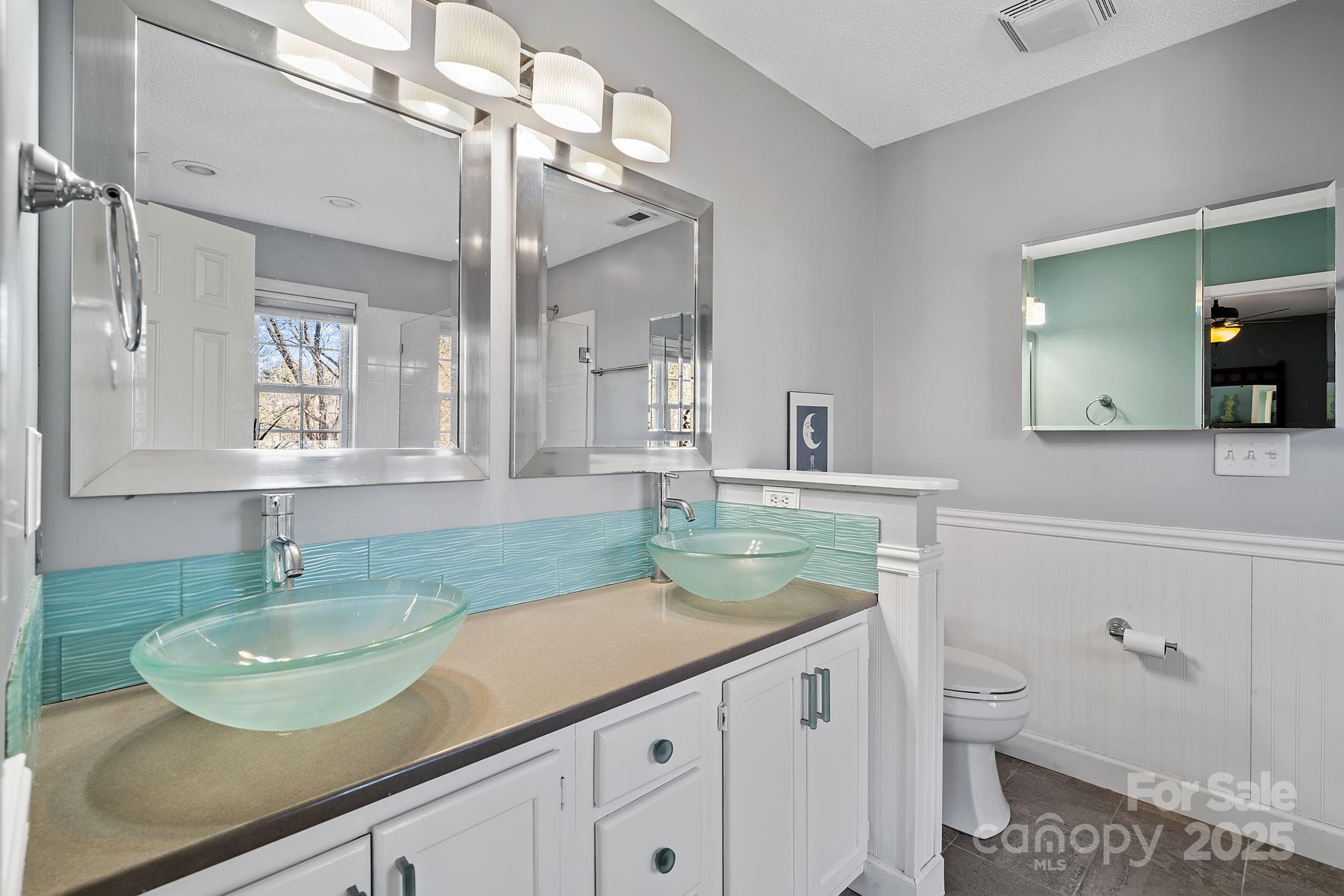 28 Sand Pebble Court Fletcher, NC 28732 - Photo 18 of 35 a bathroom with a granite countertop sink a toilet and a mirror
