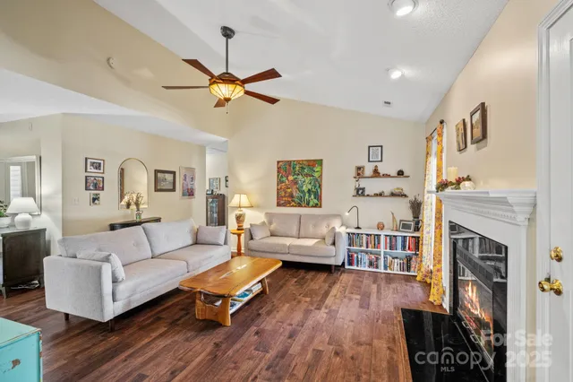a living room with furniture a fireplace and a flat screen tv