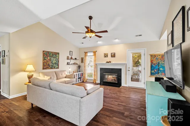 a living room with furniture a flat screen tv and a large window