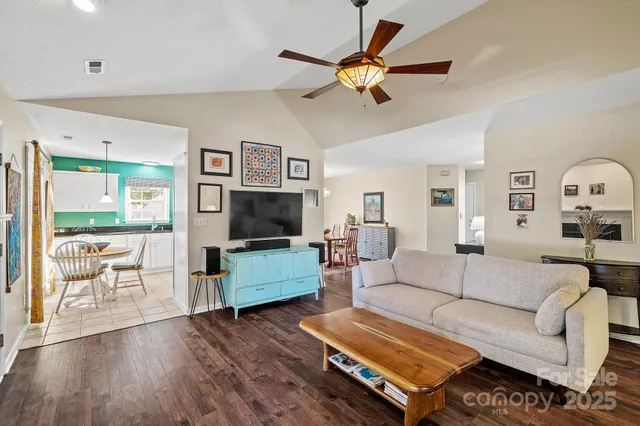 a kitchen with granite countertop lots of white cabinets and stainless steel appliances