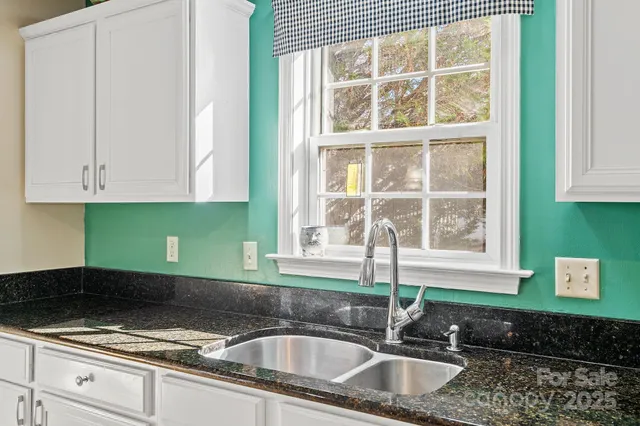 a kitchen with stainless steel appliances a refrigerator sink and microwave