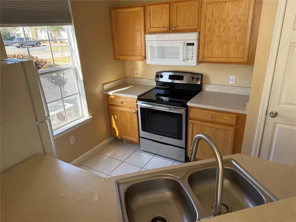 a view of a kitchen with a sink a washer and dryer